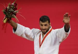 Algeria's Amar Benikhlef poses with his silver medal on