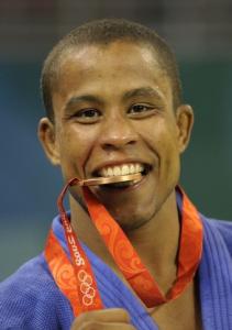 Switzerland's Sergei Aschwanden poses with his bronze medal on