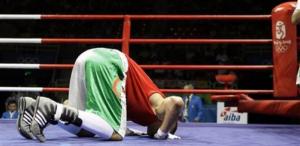 Newfel Ouatah of Algeria kisses the floor after defeating