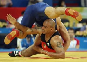 Algeria's Samir Bouguerra (red) competes with Jiang Huachen of
