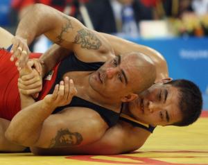 Algeria's Samir Bouguerra (red) competes with Jiang Huachen of