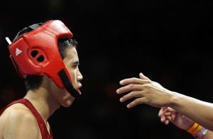 Sailom Adi of Thailand returns to his corner to