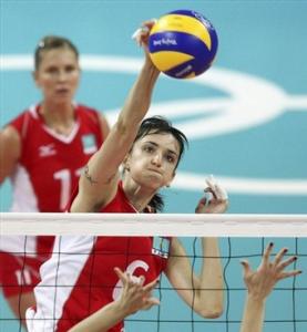 Olga Nassedkina, of Kazakhstan, spikes against Lydia Oulmou, of