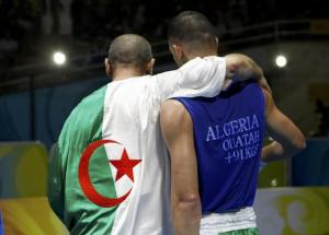 Newfel Ouatah of Algeria is comforted by a team