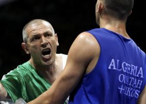 A team official argues with the referee next to