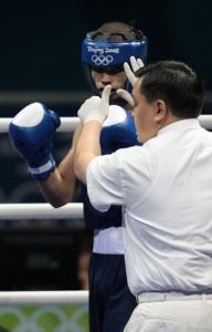 The referee counts over Algeria's Abdelkader Chadi after being