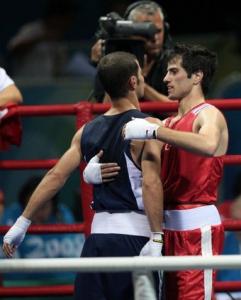 Winner Turkey's Yakup Kilic (R) huges Algeria's Abdelkader Chadi