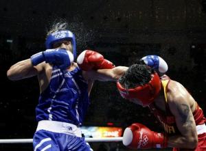 Zhang Xiaoping (R) of China fights Abdelhafid Benchabla of
