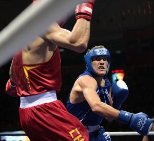 China's Xiaoping Zhang (L) fights against Algeria's Abdelhafid Benchabla