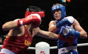 China's Xiaoping Zhang (L) fights against Algeria's Abdelhafid Benchabla
