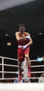 China's Xiaoping Zhang (L) celebrates his victory over Algeria's