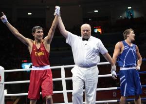 China's Xiaoping Zhang ( L) is declared winner after