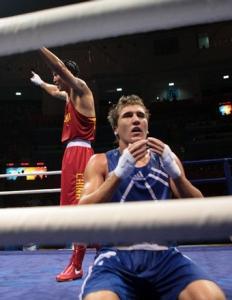 China's Xiaoping Zhang (L) celebrates his victory over Algeria's