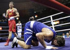 Zhang Xiaoping of China, left, reacts after defeating Abdelhafid