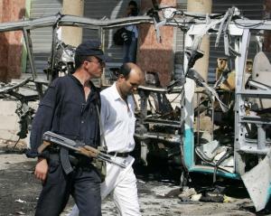An Algerian policeman (L) and a bomb disposal expert