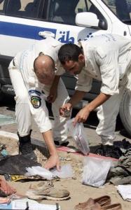 Bomb disposal experts look at evidence at the site