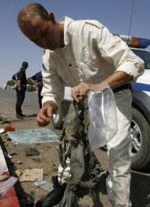 A bomb disposal expert inspects the trousers of one