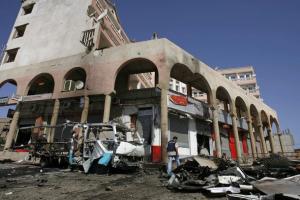 A police officer inspects the site of a car