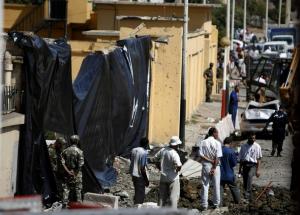 Algerian soldiers and municipal workers stand at site of