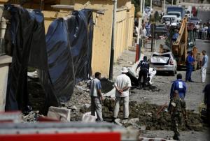 Algerian soldiers and municipal workers stand at the site
