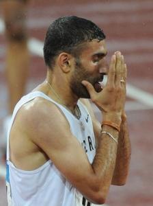 Algeria's Nabil Madi prays after winning the men's 800m