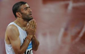 Algeria's Nabil Madi prays as he celebrates winning the