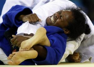 Sisilia Rasokisoki of Fiji (blue) fights with Rachida Ouerdane