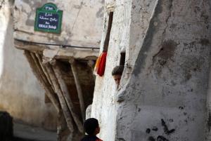 A woman talks to her child from the window