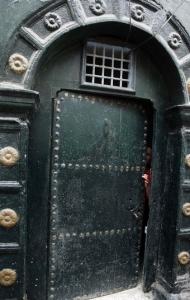 A woman looks through the door of her Moorish