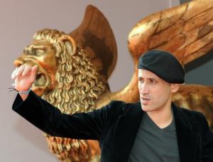 Algeria's director Tariq Teguia waves to photographers before the