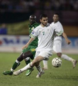 Algeria's Bezzaz Yassine (front) fights for the ball with