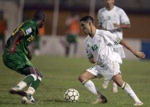 Algeria's Karim Ziani (R) fights for the ball with