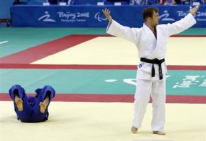 Algeria's Mouloud Noura, right, reaccts after defeating Iran's Saeed