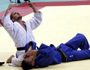 Algeria's Sidali Lamri, left, reacts after defeating Japan's Satoshi