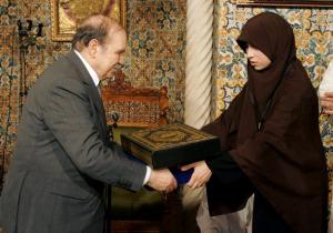 Algeria's President Abdelaziz Bouteflika (L) presents a gift to