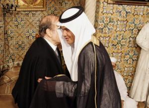 Algeria's President Abdelaziz Bouteflika (L) presents a gift to