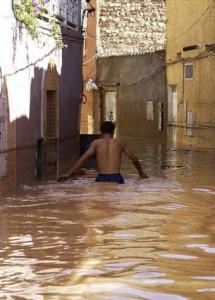 A man walks in a flooded street in Ghardaia,