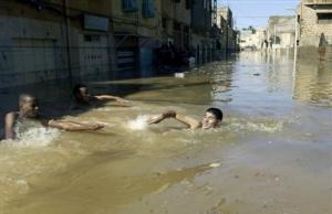 People swim in a flooded street, in Ghardaia, 600