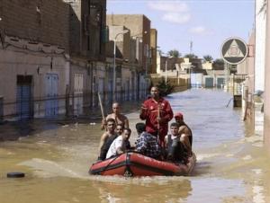 Residents use an inflatable boat in a flooded street