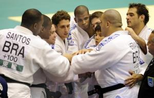 Members of Brazil's judo team celebrate their win over