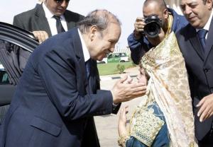 Algeria's President Abdelaziz Bouteflika smiles as he is greeted