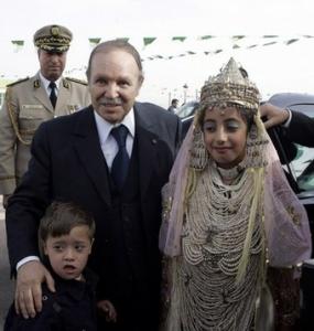 Algeria's President Abdelaziz Bouteflika pose with children at a