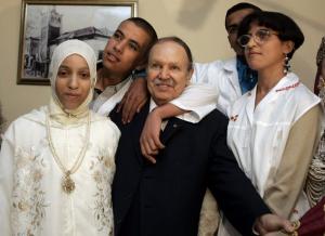 Algeria's President Abdelaziz Bouteflika (C) pose with children at