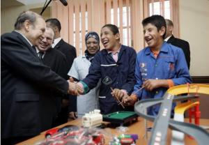 Algeria's President Abdelaziz Bouteflika (L) shakes hands with a