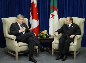 Canada's Prime Minister Stephen Harper (L) speaks with Algeria's