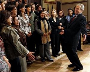 President Bush, right, reacts after posing for a photo