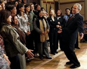 President Bush, right, reacts after posing for a photo