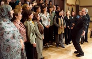 US President George W. Bush (R) speaks with participants