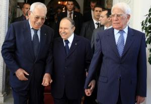 Algeria's President Abdelaziz Bouteflika (C) smiles as he walks
