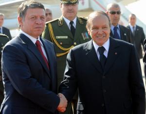 Algerian President Abdelazziz Bouteflika (R) shakes hand with Jordanian